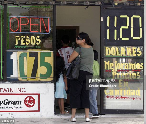 Woman waits in line at a ?Casa de Cambio? money exchange business in Brownsville, Texas, Monday July 24, just blocks from the border crossing into...
