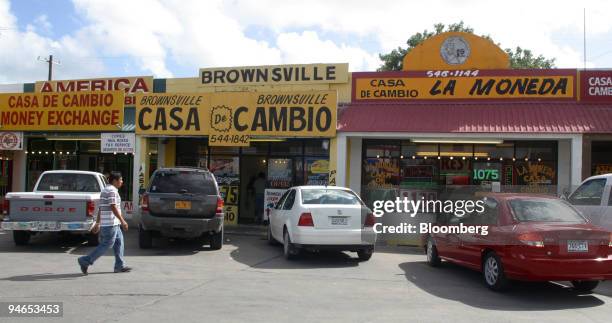 Man walks toward some "Casa de Cambio" money exchange businesses in a strip mall in Brownsville, Texas, just blocks away from the border crossing...