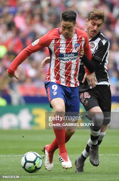 Atletico Madrid's Spanish forward Fernando Torres vies with Levante's Spanish midfielder Jose Campana during the Spanish league football match...