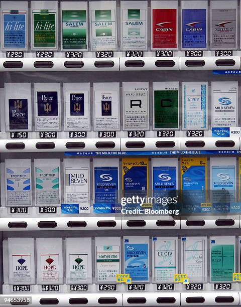 Cartons of cigarettes are displayed inside a cigarette vending machine in Tokyo, Japan, Monday, July 24, 2006. Japan Tobacco Inc., the world's...