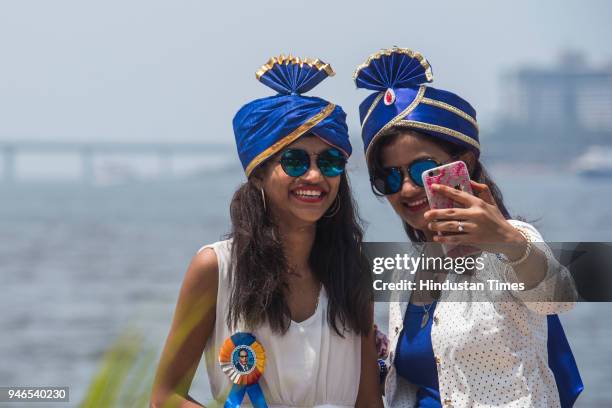 Two girls click selfie wearing blue colour Pheta as they come to pay homage on the occasion of 127th birth anniversary of Dr Babasaheb Ambedkar, on...