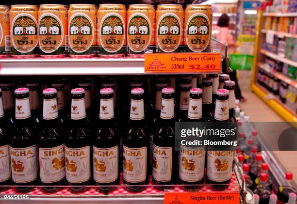 Cans of Thai Beverage Pcl's Chang Beer, above, are pictured on a supermarket shelf in Singapore on Sunday, May 7, 2006. Thai Beverage Pcl, Thailand's...