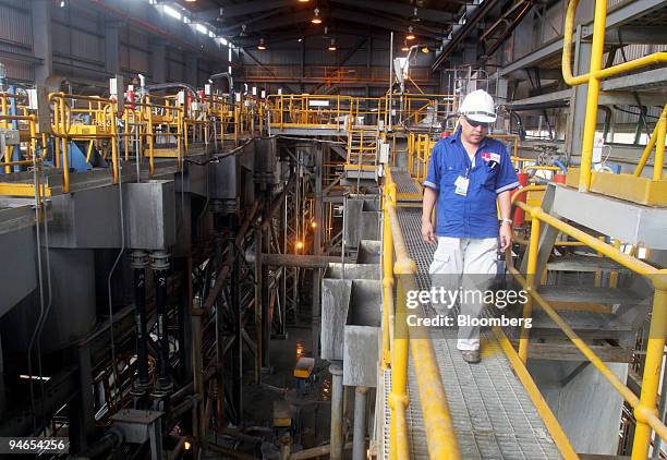 Mining officer officer walks through the zinc and copper processing plant of the Lafayette Mining Ltd.'s Rapu Rapu copper, gold and silver mine on...