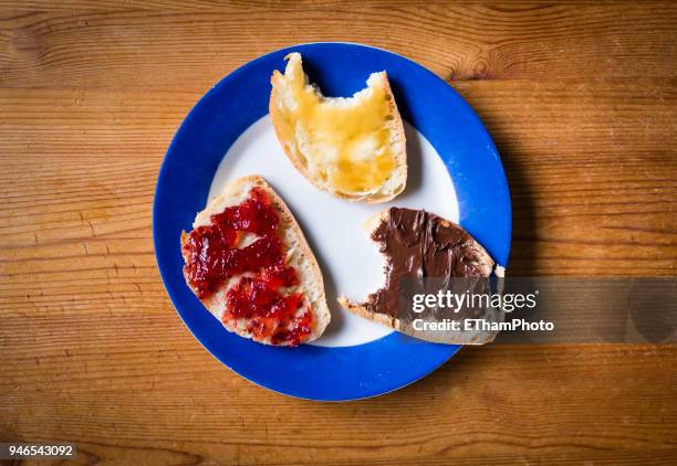 healthy breakfast with slices of bread with marmalade, honey and hazelnut spread - marmalade sandwich stock pictures, royalty-free photos & images