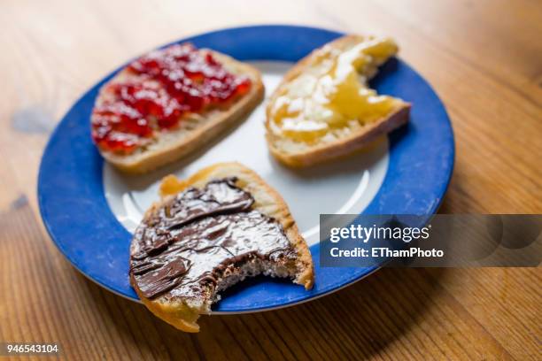 healthy breakfast with slices of bread with marmalade, honey and hazelnut spread - marmalade sandwich stock pictures, royalty-free photos & images