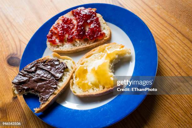 healthy breakfast with slices of bread with marmalade, honey and hazelnut spread - marmalade sandwich stock pictures, royalty-free photos & images