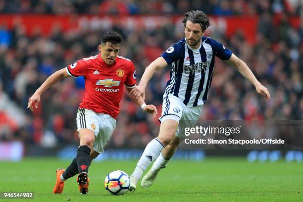 Alexis Sanchez of Man Utd battles with Jay Rodriguez of West Brom during the Premier League match between Manchester United and West Bromwich Albion...