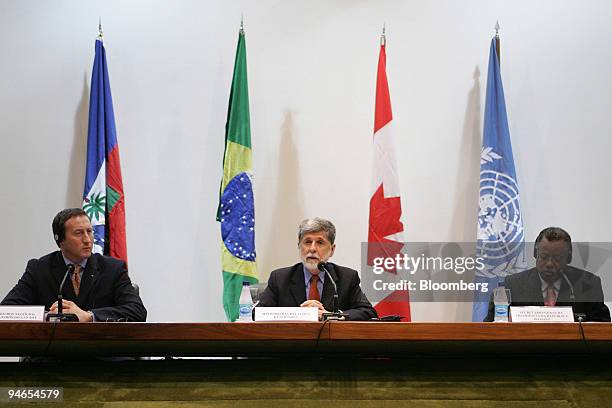 Brazilian Foreign Minister Celso Amorim speaks while Canadian Foreign Minister Peter MacKay, left, and General Secretary for the Presidency of Haiti...