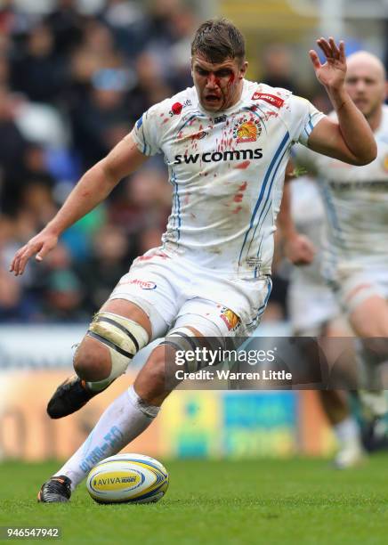 Sam Skinner of Exeter Chiefs controls the ball with his foot as he nurses a blood injury during the Aviva Premiership match between London Irish and...
