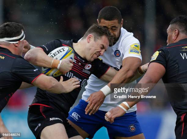 Chris Wyles of Saracens tackled by Taulupe Faletau of Bath during the Aviva Premiership match between Saracens and Bath Rugby at Allianz Park on...