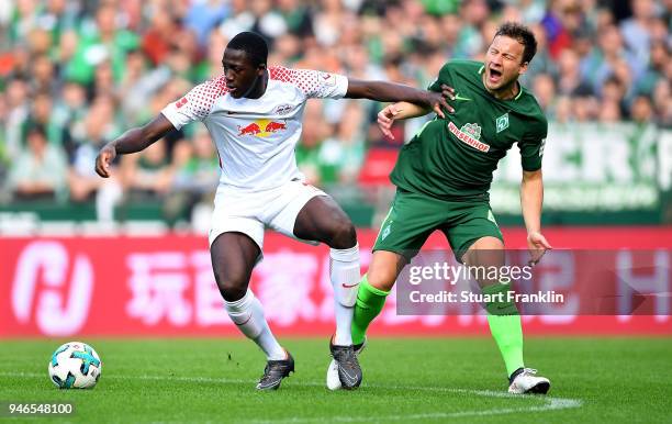 Philipp Bargfrede of Bremen and Ibrahima Konate of Leipzig battle for the ball during the Bundesliga match between SV Werder Bremen and RB Leipzig at...