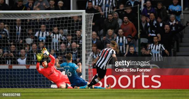 Matt Ritchie of Newcastle United scores his sides second goal past Petr Cech of Arsenal while being challenged by Rob Holding of Arsenal during the...