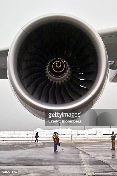 Photographer stands under the engine of the Airbus A380 at Vancouver International Airport , British Columbia, Canada, Wednesday, November 29...