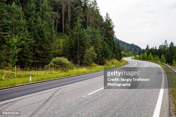 asphalt road along the forest in austria - country road stock pictures, royalty-free photos & images