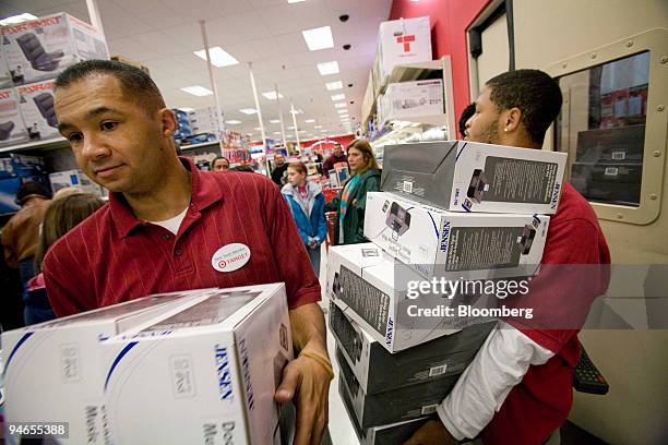 Target employees Jay Howard, left, and Corey Smith, right restock Jensen Docking Digital Music Systems for iPods at the Target in Spotsylvania,...