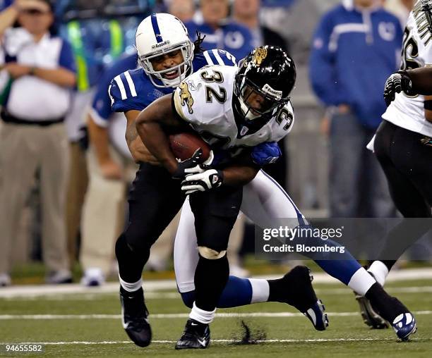 Maurice Jones-Drew, No. 32, running back for the Jacksonville Jaguars, is tackled by Bob Sanders of the Indianapolis Colts during the third quarter...