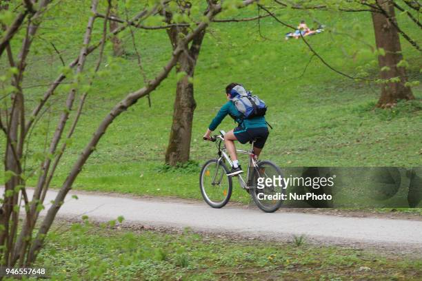 Man rides his bike on a cloudy spring day in Munich.