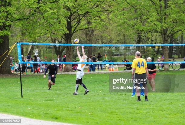 Some people play volley on a cloudy spring day in Munich.