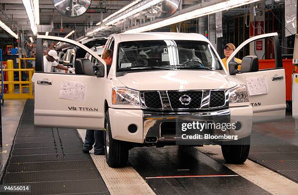 Nissan Motor Co. Assembly line workers give a 2007 Nissan Titan its final inspection at the Nissan North America assembly plant in Canton,...