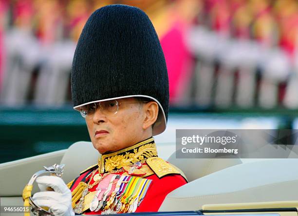Thai King Bhumibol Adulyadej, rides in an open car during a military parade in Bangkok, Thailand, on Sunday, Dec. 2, 2007. King Bhumibol is revered...