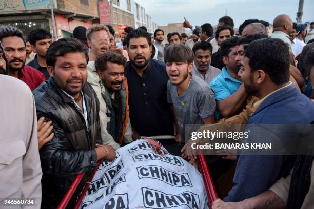 Pakistani Christians mourn the death of relatives who were killed in a drive-by shooting outside a church, at a hospital in Quetta on April 15, 2018....