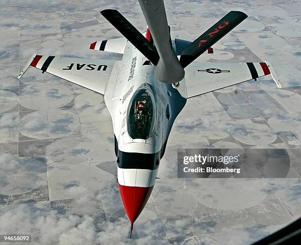 United States Airforce USAF F-16 Thunderbird pilot flies over the pan handle of Texas and pulls up to the boom for refueling from a KC-135R flying...