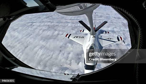 United States Airforce USAF F-16 Thunderbird pilot flies over the pan handle of Texas and pulls up to the boom for refueling from a KC-135R flying...