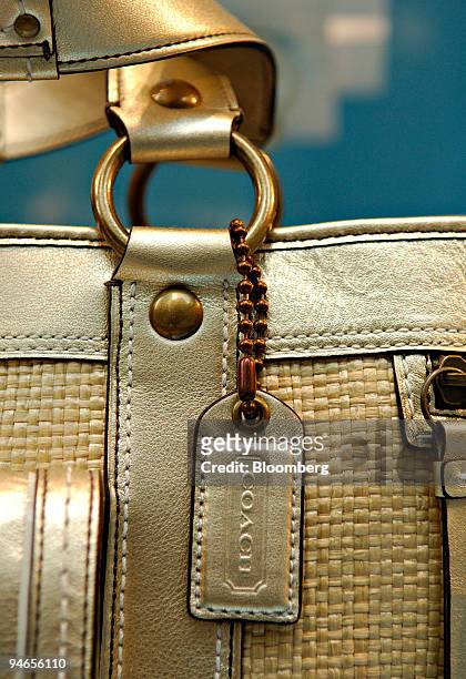 Coach tag hangs on a handbag on display in the window of a Coach store in New York, Tuesday, April 25, 2006. Coach Inc. Said fiscal third-quarter...