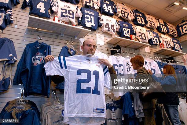 Matt Corns of Mitchell, Indiana, models an Indianapolis Colts jersey for his wife in the team's Pro Shop at Circle Center Mall near the RCA Dome,...