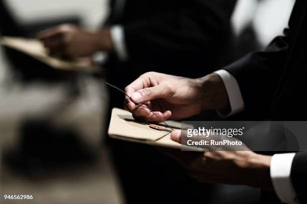 close up of businessman opening envelope - envelope stock pictures, royalty-free photos & images