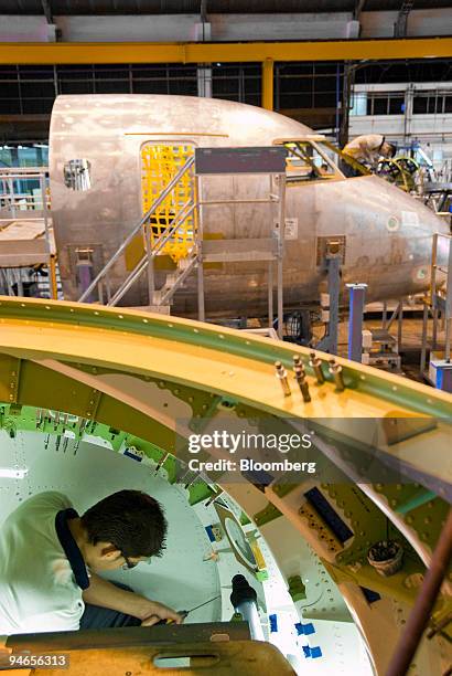 An employee works on the Embraer structural assembly line of the airplane model 170-190 at the Empresa Brasileira de Aeronautica S.A., Embraer,...