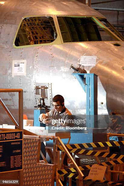 An employee works on the Embraer structural assembly line of the airplane model 170-190 at the Empresa Brasileira de Aeronautica S.A., Embraer,...