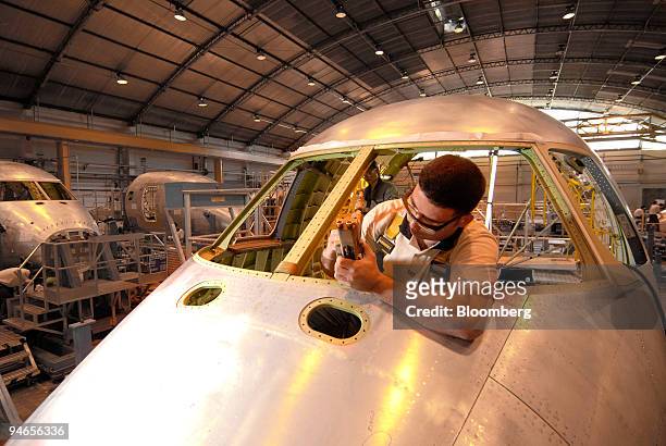 An employee works on the Embraer structural assembly line of the airplane model 170-190 at the Empresa Brasileira de Aeronautica S.A., Embraer,...