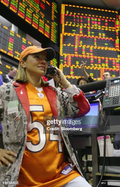 Virginia McGathey, a broker at the Chicago Board of Trade, wears a Chicago Bears Brian Urlacher jersey on the floor in Chicago, Illinois, on Friday,...