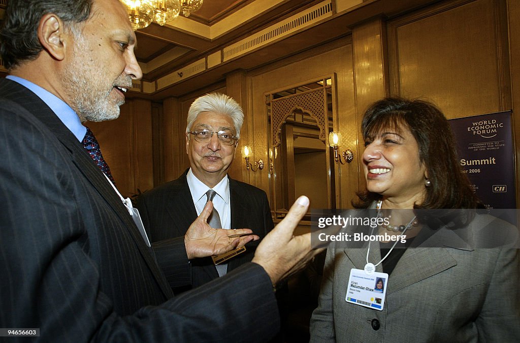 Wipro Chairman Azim H. Premzi, center, listens as NIIT Group