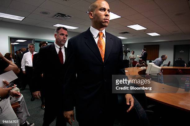 Newark Mayor Cory A. Booker, right, walks into a press conference followed by Newark Police Director Garry McCarthy, to announce the arrest of...