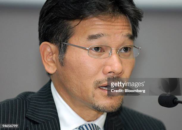 Joji Tagawa, corporate vice president of Nissan Motor Co., speaks at a news conference announcing Nissan's third-quarter results at the company's...