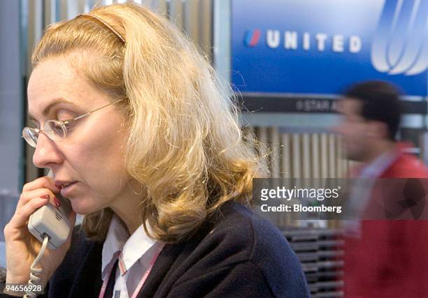 United Airlines Service Director B.J. Sert assists a customer at Logan International Airport in Boston, Massachusetts, Friday, April 7, 2006. United...