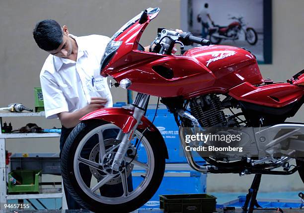 An employee of Bajaj Auto Limited puts the finishing touches to Bajaj Pulsar, during production at the company's plant in Chakan, India, on Thursday,...