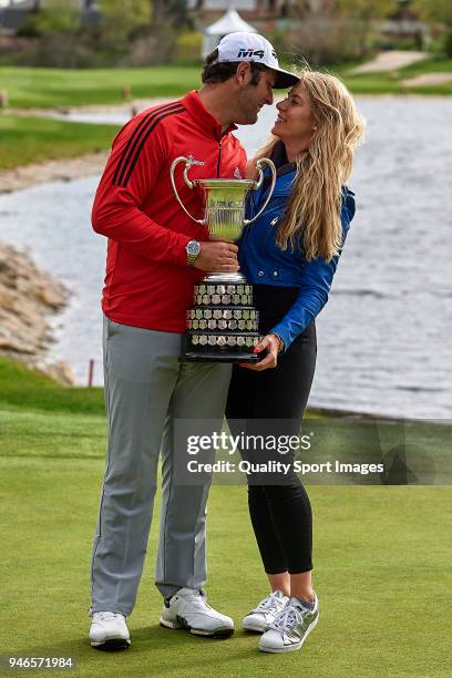 Jon Rahm of Spain and his girlfriend Kelley Cahill pose with the trophy after winning the Open de Espana during day four of Open de Espana at Centro...