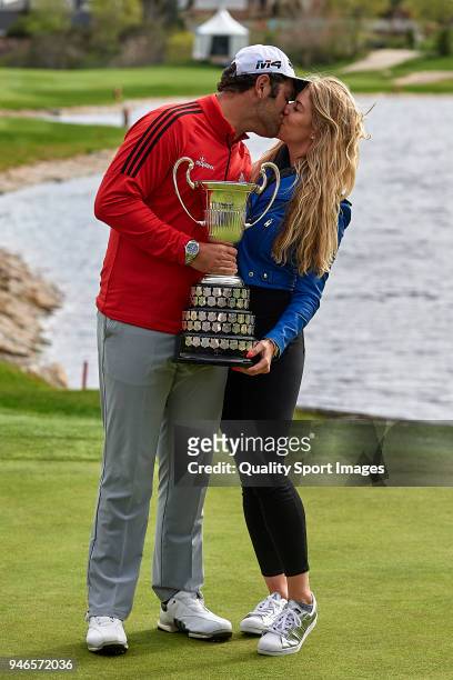 Jon Rahm of Spain and his girlfriend Kelley Cahill pose with the trophy after winning the Open de Espana during day four of Open de Espana at Centro...