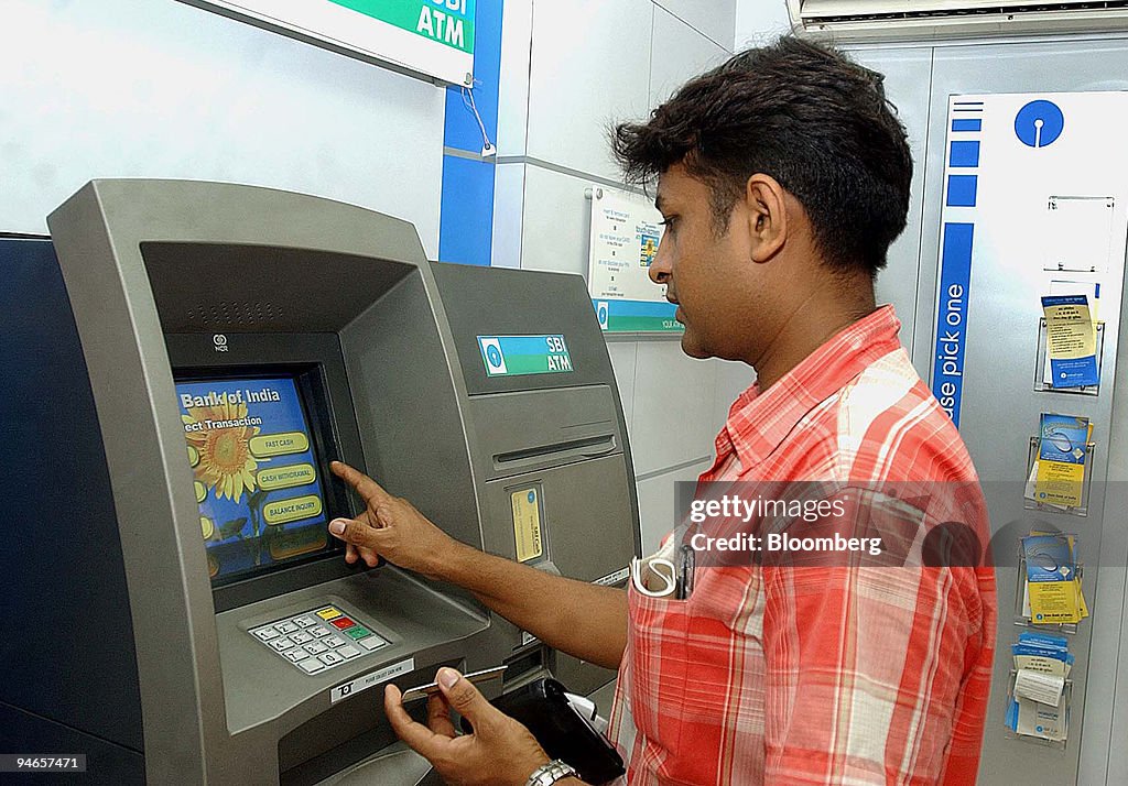 Atm Machine Withdraw A customers uses an ATM machine to withdraw cash inside a branch of ...