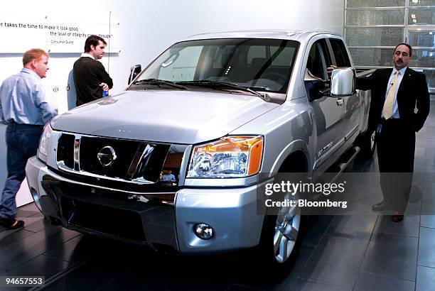 Larry Dominique, right, vice president of product planing for Nissan North America, shows off the new Nissan Titan full-size pickup truck at the...