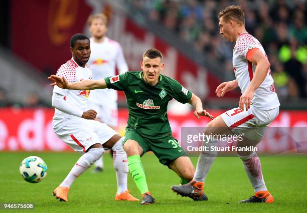 Maximilian Eggestein of Bremen and Ademola Lookman and Willi Orban of Leipzig battle for the ball during the Bundesliga match between SV Werder...