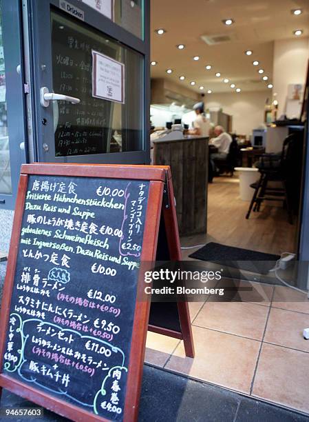 The menue of the day, written in German and Japanese, sits outside a Japanese restaurant in Dusseldorf, Germany, on Wednesday, Aug. 8, 2007. Within...