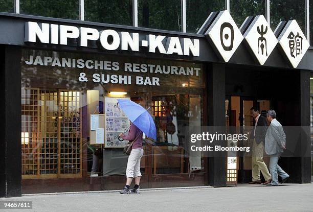 People enter a Japanese restaurant in Dusseldorf, Germany, on Wednesday, Aug. 8, 2007. Within five days last month, two of the city's biggest banks,...