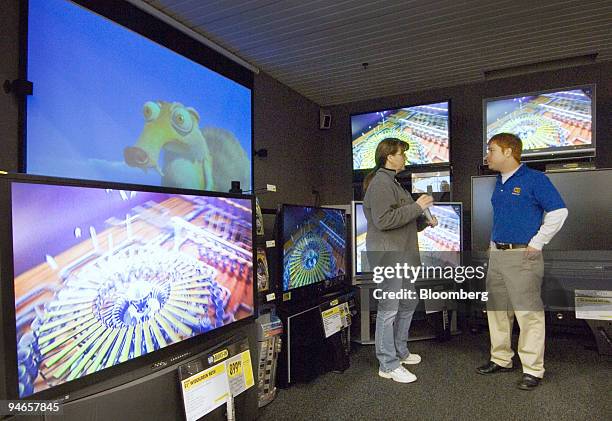 Mona Karr talks with salesman David Gelo about high definition televisions on display at a Best Buy store in Columbus, Ohio, Wednesday, April 4,...