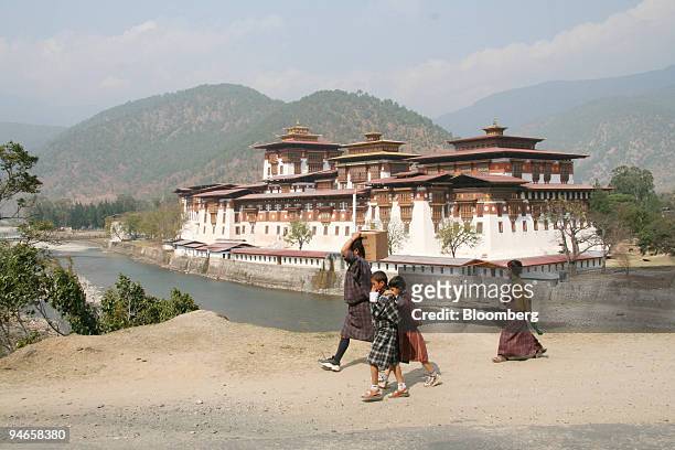 People walk on a road above the dzong in Punakha, Bhutan on Wednesday, March 8, 2006. "Turn right at Mrs. Smith's House" is one of the directions for...