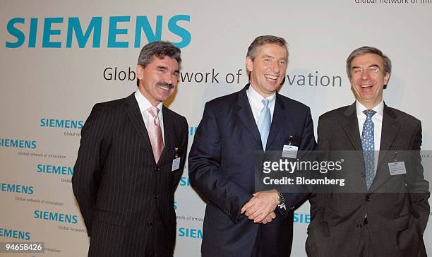 Joe Kraemer, left, designated chief financial officer of Siemens AG, Heinz-Joachim Neubuerger, center, current chief financial officer and Siemens...