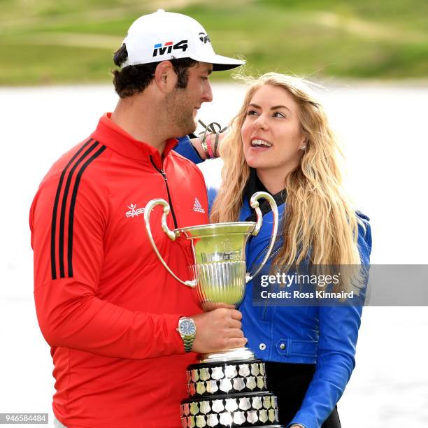 Jon Rahm of Spain and his girlfriend Kelley Cahill celebrate with winners trophy after the final round of the Open de Espana at Centro Nacional de...